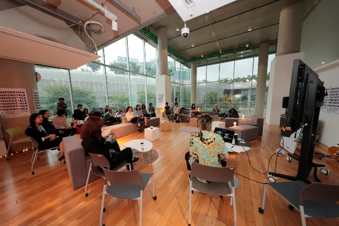 a group of people sitting in chairs in a room